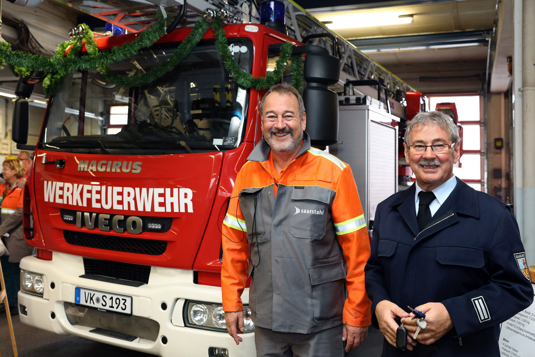 Vor der neuen Drehleiter: Arbeitsdirektor Peter Schweda und der zum Leitenden Werkbrandoberinspektor ernannte Wolfgang Besse (Foto: Saarstahl AG)